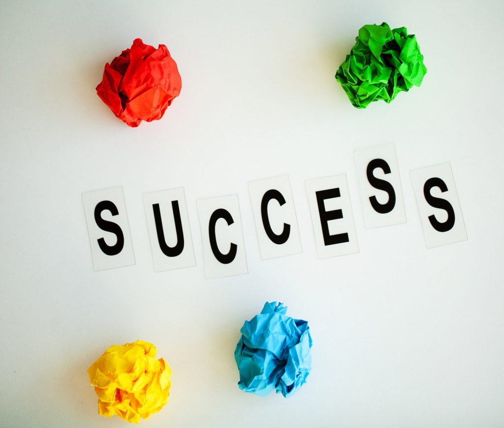 Success word written on white table. Copy space